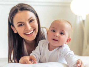 Madre sonriendo junto a su bebé en primer plano